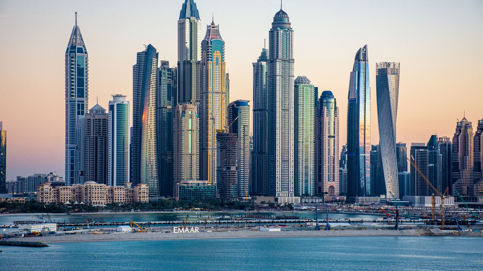 Dubai Marina skyline at dusk, lined with high-rise residential towers
